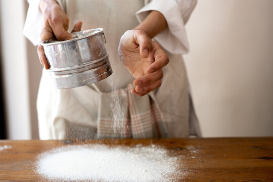Woman Hands Sifting Flour For Baking
