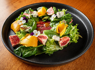 Italian gourmet salad with prosciutto, cheese and figs