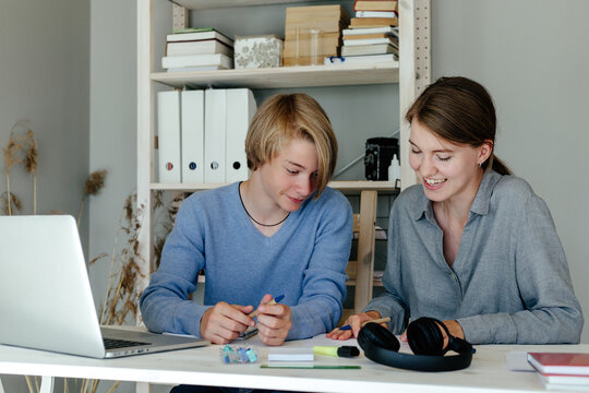 Students doing home task together at home