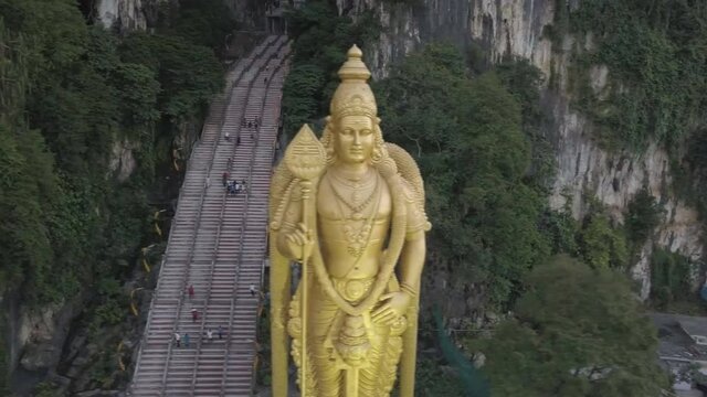 The Batu Caves and the colossal statue of Lord Murugan in Kuala Lumpur, Malaysia. (aerial photography)