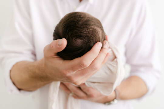 Up close of a man holding baby