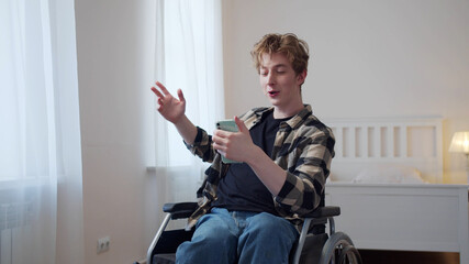 Fototapeta na wymiar A beautiful disabled man is talking with his friend on the Internet 