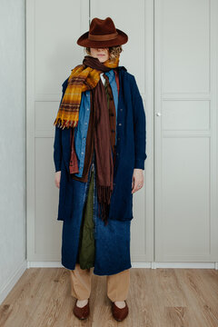 Woman in layered outfit and hat