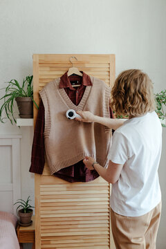 Woman preparing clothes for ad on Internet