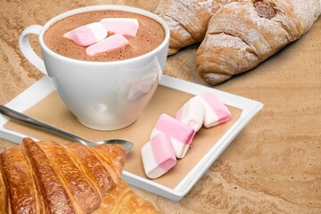 Fresh delicious breakfast with Coffee, crispy croissants on desk