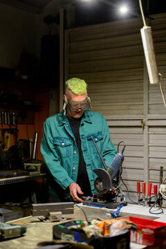 Senior man working on his garage workshop