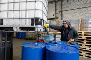 Worker at the chemical tank