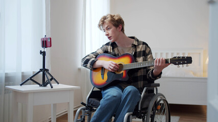 A disabled man is teaching how playing the guitar professionally