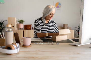Female worker opening a package at office