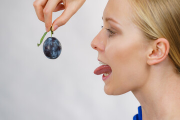 Girl holds plum fruit