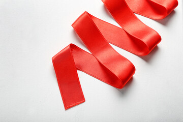 Red ribbon on white background, closeup