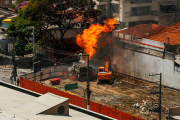 Huge fire flame caused by a gas leak in a pipe under a street in São Paulo. The city famous for its cultural and business vocation in Brazil.