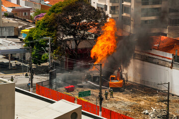 Firefighters fighting a fire caused by a gas leak in a street of São Paulo. The city famous for its cultural and business vocation in Brazil.