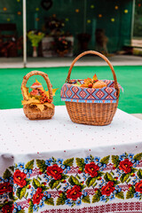 Fototapeta na wymiar Two baskets with autumn fruits and vegetables are on the table in the yard 