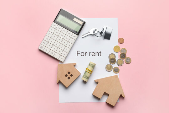 Text FOR RENT with money, wooden houses, key and calculator on pink background
