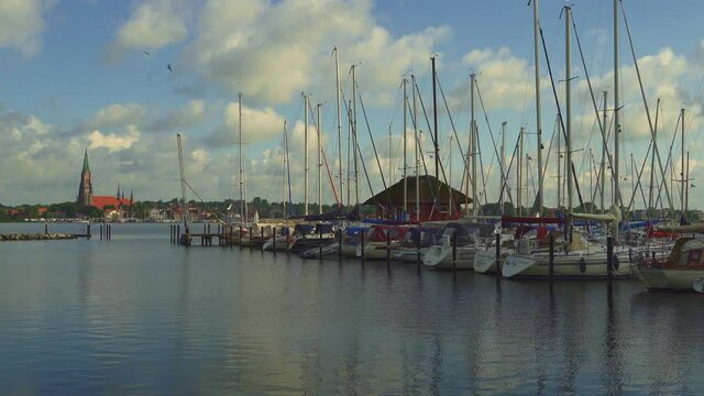 Busdorf marina, Haddeby. In the background the bell tower of the cathedral of St. Peter . Schleswig, Schleswig-Flensburg, Schleswig-Holstein, Germany