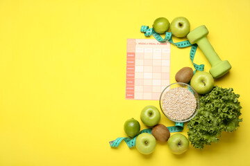 Naklejka na ściany i meble Healthy products, meal plan, dumbbell and measuring tape on yellow background
