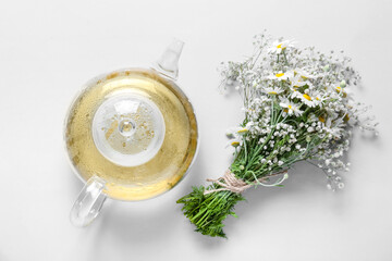 Obraz na płótnie Canvas Teapot of fresh chamomile tea on white background