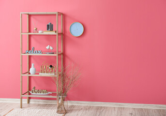 Stylish wooden shelf unit with decor in interior of room