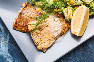 Plate with tasty baked cod fillet and vegetables on color background, closeup
