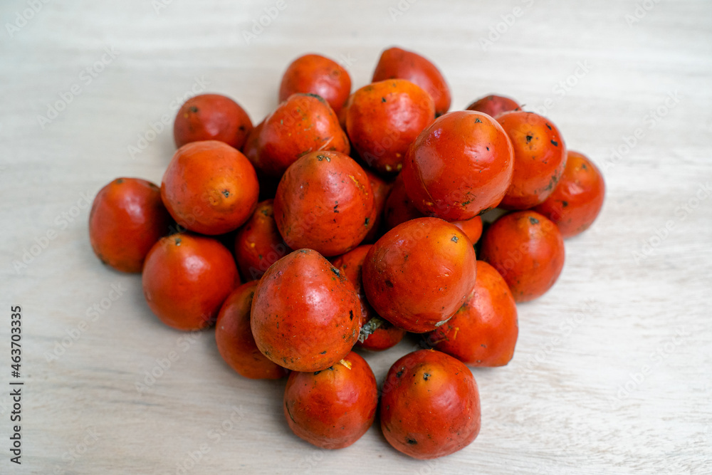 Poster heap of chontaduro fruits on the light surfac