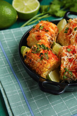 Frying pan with tasty Elote Mexican Street Corn on table, closeup