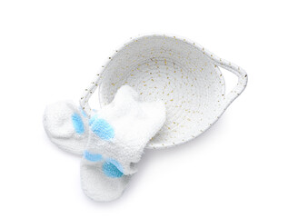 Basket and warm socks on white background