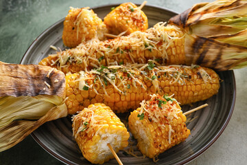 Plate with delicious Elote Mexican Street Corn on table