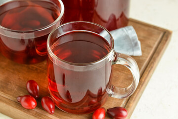 Cup of healthy dogwood berry drink on table