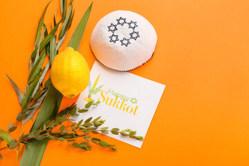 Sukkot festival symbols and greeting card on color background