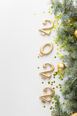 Composition with fir branches and figure 2022 on white background, closeup