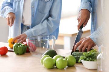 Young couple cooking in kitchen. Vegan Day