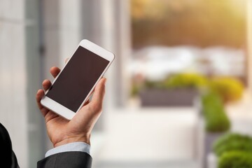 Human texting with phone outdoors. Text message with smartphone.