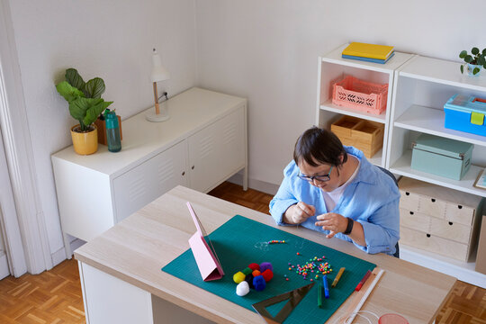 Craftswoman with Down syndrome working in studio