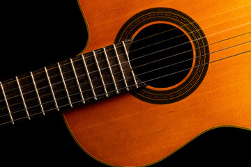 Obraz na płótnie Canvas Close-up guitar in black backdrop