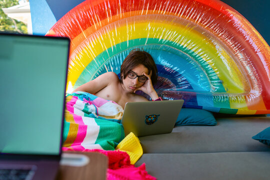 Bored teen watching film on netbook