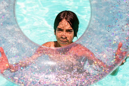 Teenager showing transparent float in pool