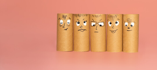 group of characters made from toilet paper rolls with painted face expressing happiness or...