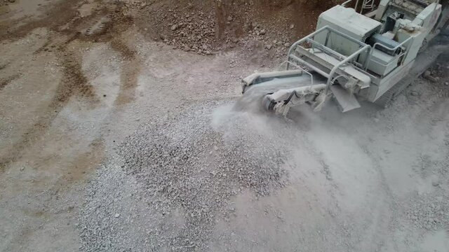 Conveyor belt of an aggregate crusher working in a quarry. Manufacturing graded crushed aggregate