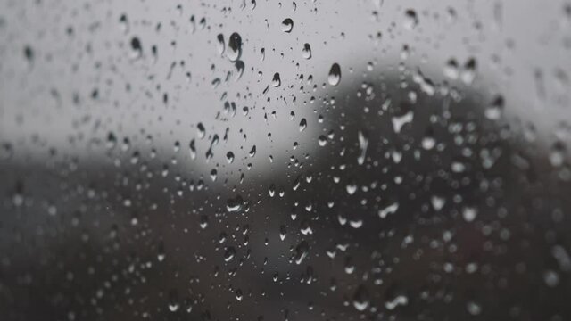 strong rain creating water drops on window glass in strong rain autumn weater