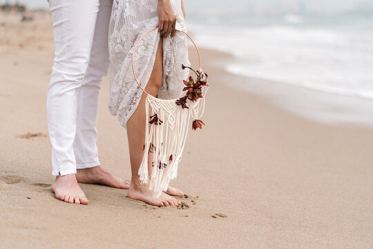 Newlyweds with dream catcher on beach