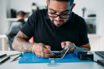 Engineer using tool to fix smartphone
