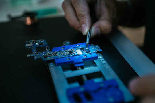 Technician measuring current on micro scheme