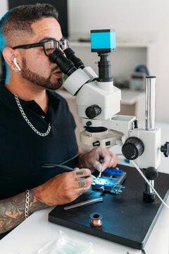 Male technician measuring current on device
