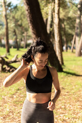 adult Caucasian woman exercising on a mat in the forest
