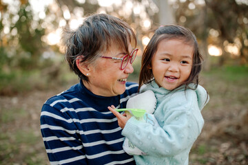 Happy grandmother holding granddaughter