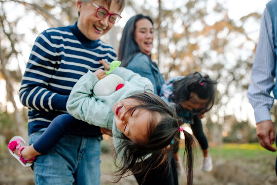 Laughing grandmother with wiggly girl