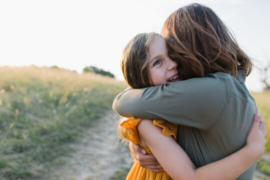 A girl hugging her mother