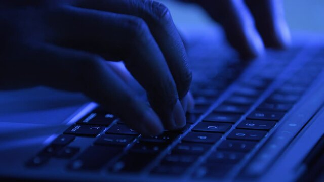 Hands typing on a keyboard