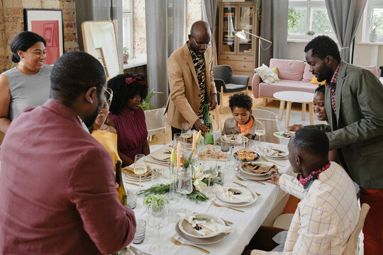 Family Gathering At Dining Table
